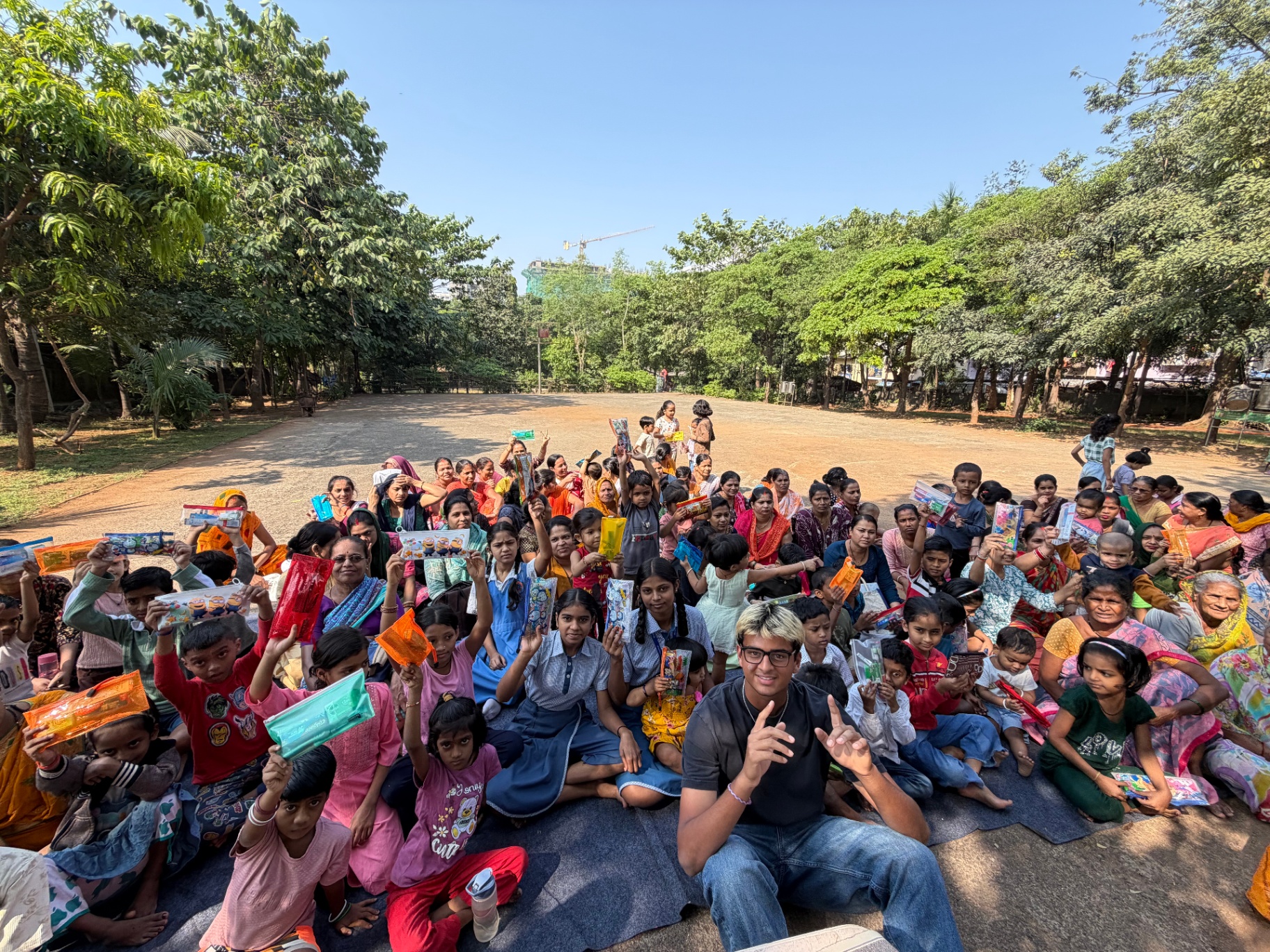 Mark Makers community gathering with children holding books